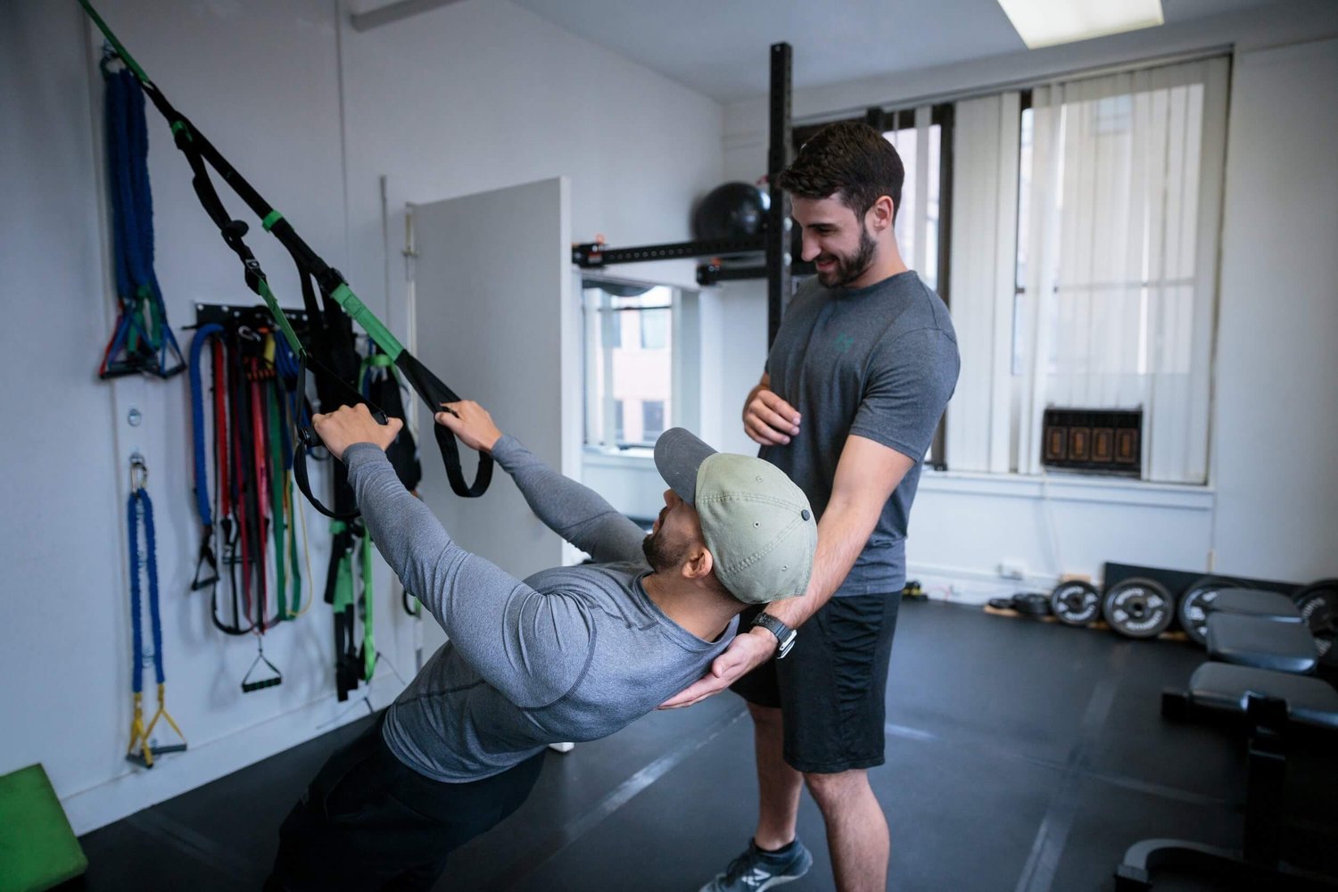 a man and a woman working out in a gym.