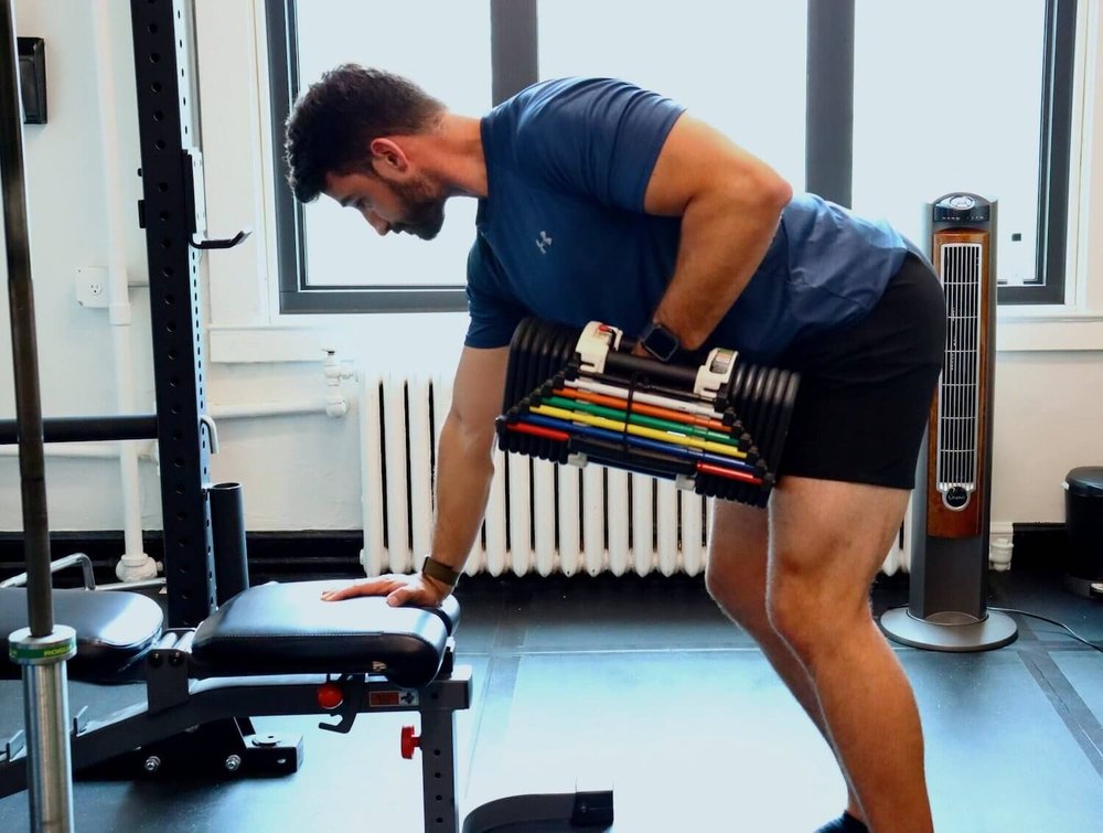 a man lifting a dumbbell in a gym.